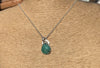 Emerald gemstone and silver pendant