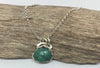 Emerald gemstone and silver pendant