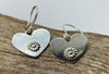 Heart shaped earrings with a flower motif.