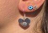 Heart shaped earrings with a flower motif.