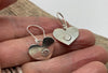 Heart shaped earrings with a flower motif.