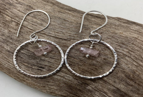 Gemstones suspended in a sterling silver circle